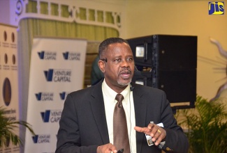 General Manager, Microfinance Services Division,  Development Bank of Jamaica (DBJ), Paul Chin, addresses the DBJ’s Small and Medium-size Enterprise (SME) Summit, at the Knutsford Court Hotel in New Kingston.