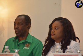 Minister without Portfolio in the Ministry of Industry, Commerce, Agriculture and Fisheries, Hon. J.C. Hutchinson (left), and Programme Director for the Agricultural Competitiveness Programme (ACP), Petronia Colley, listen attentively to a presentation at the two-day training seminar on ‘Farm Enterprise Management’, held at the Hyatt Ziva/Zilara Rose Hall hotel, Montego Bay, St. James, on August 29.