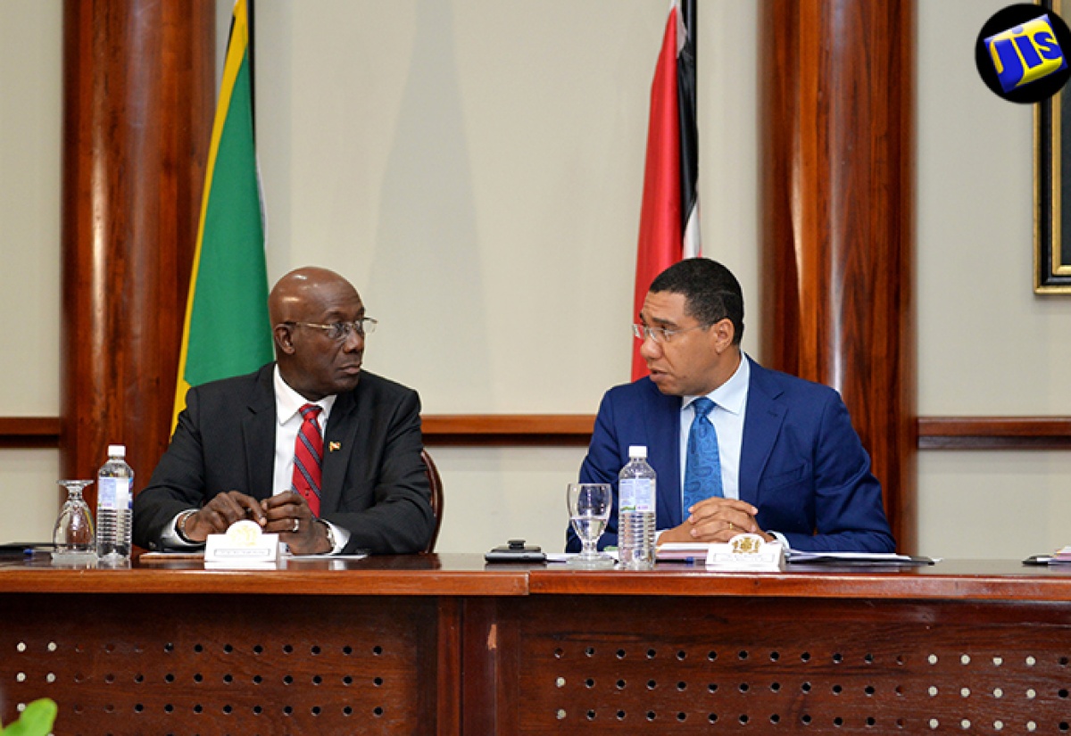 Prime Minister, the Most Hon. Andrew Holness (right), makes a point to Prime Minister of the Republic of Trinidad and Tobago, Dr. the Hon. Keith Rowley, before the official start of a bilateral meeting at the Office of the Prime Minister on Monday (July 18). Dr. Rowley is in the island for a four-day official visit.
