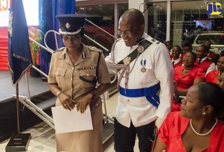 Acting Commissioner of Police, Novelette Grant (left), is being guided to her seat by Head of the JCF’s Community Safety and Security Branch, Assistant Commissioner of Police (ACP), Bishop Dr. Gary Welsh, at the launch of the JCF 150th anniversary celebrations, held recently at Toyota Jamaica on Old Hope Road, St. Andrew.