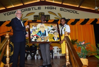 Minister of Education, Hon. Rev. Ronald Thwaites (left) is gifted with a painting by Art Teacher at York Castle High School, Akimeo Timoll (centre) and student, Tabia Mae. The painting, which depicts the Minister and York Castle  Principal, Raymond Treasure, was presented at the official launch of the Sixth Form programme at the school on November 19.