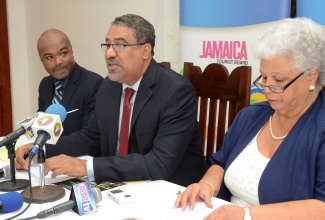 Tourism and Entertainment Minister, Hon. Dr. Wykeham McNeill (centre), addresses a press briefing to give an update on developments at the site, held at its  Hope Road location on November 17. Listening are Marketing and Events Manager at Devon House, Andre Reid (left) and Executive Director of the facility, Janet Taylor. 