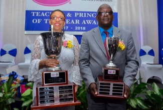 Ministry of Education, Youth and Information/LASCO 2017 Principal of the Year, Howard Salmon (right), and Teacher of the Year, Ingrid Peart-Wilmot, display their trophies during the awards ceremony at the Jamaica Pegasus Hotel, New Kingston, in December. 