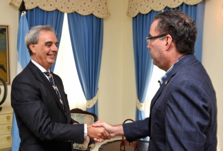 Minister without Portfolio in the Ministry of Economic Growth and Job Creation, Hon. Daryl Vaz (right), greets Argentina’s Ambassador to Jamaica, His Excellency Ariel Fernandez, during a courtesy call by the Ambassador at the Ministry’s New Kingston offices on July 12.