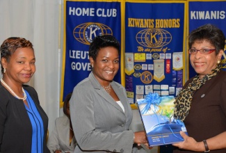 Executive Director of the National Parenting Support Commission (NPSC), Dr. Patrece Charles-Freeman (centre), accepts a book on the history of the Kiwanis Club in Jamaica from Lieutenant Governor, Kiwanis Club of New Kingston, Beverley Thompson (right), at the launch of the Kiwanis Club of New Kingston’s spelling event, ‘Little Bee Competition’, held at the Police Officers Club, Hope Road,  on March 30. At left is President of the club,  Audrey Brown.