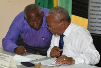 Chairman of the Minimum Wage Advisory Commission, Silvera Castro (right), in discussion with President of the Union of Clerical, Administrative and Supervisory Employees (UCASE), Vincent Morrison. Occasion was the final session in a series of islandwide consultations on the national minimum wage at the North Street Offices of the Ministry of Labour and Social Security in downtown Kingston, on July 13.