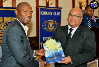 Chief Executive Officer of the Jamaica Customs Agency (JCA), Major (Ret’d) Richard Reese (right), is presented with a gift by President of the Kiwanis Club of downtown Kingston, Hugh Meredith, during the service organisation’s meeting at Hotel Four Seasons on Monday, July 25. Major Reese, who is also the Commissioner of Customs, was the guest speaker.