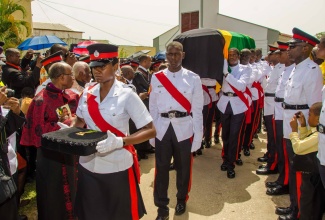 Members of the Jamaica Constabulary Force’s (JCF) Bearer Party exit St. George’s Anglican Church in Savanna-la-Mar, Westmoreland with the flag-draped casket bearing the body of late Agriculture and Fisheries Minister, Hon. Roger Clarke, following Saturday’s (September 13) Official Funeral Service. Mr. Clarke was interred in the family plot at Glen Islay in his home district of Williamsfield, in Westmoreland.