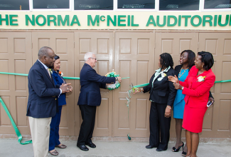 Education Minister, Hon. Rev. Ronald Thwaites (3rd left),  and Principal, Pembroke Hall Primary School, Norma McNeil (3rd right), cut the ribbon to open the Norma McNeil Auditorium at the school in Kingston on November 26. Others (from left) are: Member of Parliament for North Western St. Andrew, Derrick Smith; representative of the Greater Works International Fellowship, Ann McCarthy; Past President, Parent-Teachers Association (PTA), Sonia Morgan; and School Board Chairman, Novlette Howell. 