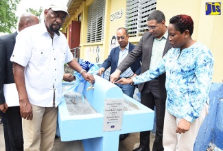 Prime Minister, the Most Hon. Andrew Holness (centre), turns on the $38-million Palmetto Pen/Breadnut Bottom/Rosewell Water Supply Project at the official commissioning of the project on the grounds of the Rosewell Primary School, recently.  Others (from left) are Minister without Portfolio in the Ministry of Economic Growth and Job Creation, Hon. Dr. Horace Chang; Senator Aubyn Hill; Member of Parliament for South East Clarendon, Hon. Rudyard Spencer; and Mayor of May Pen, Councillor Winston Maragh.