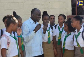 Minister of Education, Youth and Information, Senator the Hon. Ruel Reid (third left), interacts with female students of the Knockalva Agricultural School who had just returned from a practical exercise. The Minister visited the institution on January 30.