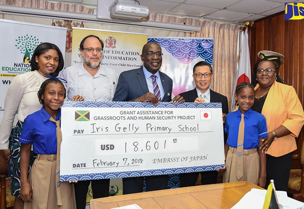 Minister of Education, Youth and Information, Senator the Hon. Ruel Reid (centre), along with (from left): Student, Iris Gelly Primary School, Daneille James; Director, Donor and Partnership Management, National Education Trust, Latoya Harris; Member of Parliament for St. Andrew Southern, Mark Golding; Japanese Ambassador to Jamaica, His Excellency Hiromasa Yamazaki; Student, Shantel Francis and Principal, Iris Gelly Primary, Veronica Gaynor, display a symbolic cheque during a signing ceremony held at the Education Ministry’s Heroes Circle offices on Wednesday (February 7).  The J$2 million (US$18,601) will be used to implement a water harvesting and sanitation solution.




