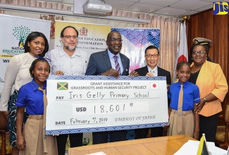 Minister of Education, Youth and Information, Senator the Hon. Ruel Reid (centre), along with (from left): Student, Iris Gelly Primary School, Daneille James; Director, Donor and Partnership Management, National Education Trust, Latoya Harris; Member of Parliament for St. Andrew Southern, Mark Golding; Japanese Ambassador to Jamaica, His Excellency Hiromasa Yamazaki; Student, Shantel Francis and Principal, Iris Gelly Primary, Veronica Gaynor, display a symbolic cheque during a signing ceremony held at the Education Ministry’s Heroes Circle offices on Wednesday (February 7).  The J$2 million (US$18,601) will be used to implement a water harvesting and sanitation solution.




