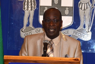 Education, Youth and Information Minister, Senator the Hon. Ruel Reid, addressing journalists at the weekly post-Cabinet media briefing at the Office of the Prime Minister (OPM), on April 13.