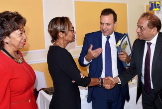 Chief of Trade and Investment at the Inter-American Development Bank (IDB) Fabrizio Opertti (2nd right), introduces Inter-American Development Bank (IDB) Country Representative to Jamaica, Therese Turner-Jones (2nd left), to Chief Executive Officer (CEO) of Tholons Inc., Avinash Vashistha. Looking on at left is President of Jamaica Promotions Corporation (JAMPRO), Diane Edwards.  Occasion was the presentation of a preliminary study on opportunities for growth in the services outsourcing sector at the Terra Nova All-Suite Hotel in New Kingston on January 31.