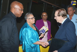 Director of the United Nations Population Fund (UNFPA) Sub-Regional Office of the Caribbean, Alison Drayton (second left), greets former  Prime Minister of Jamaica, the Most Hon. Edward Seaga (right),  following the opening ceremony for a Population Planning for Development in Jamaica conference, on January 25 at the Jamaica Conference Centre. Others (from left) are: Senior Fellow in the Sir Arthur Lewis Institute of Social and Economic Studies (SALISES), Dr. Godfrey St. Bernard; Director General of the Statistical Institute of Jamaica (STATIN), Carol Coy; and University Director, SALISES, Professor Patrick Watson. The three-day conference is being staged under the theme: ‘Theory, Practice and Policy for the Post-2015 Sustainable Development Agendas’.