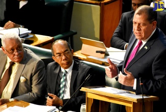 Minister of Finance and the Public Service, Hon. Audley Shaw (right), opens the 2017/18 Budget Debate in the House of Representatives on March 9. Listening are Transport and Mining Minister, Hon. Mike Henry (left); and Minister without Portfolio in the Ministry of Economic Growth and Job Creation, Hon. Dr. Horace Chang. 