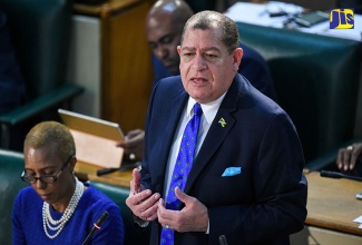 Minister of Finance and the Public Service, Hon. Audley Shaw opens the 2018/19 Budget debate in the House of Representatives on March 8. At left is State Minister in the Ministry of Finance and the Public Service, Hon. Fayval Williams 