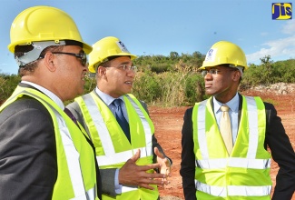 Prime Minister, the Most Hon. Andrew Holness (centre) is in discussion with Chairman of the National Housing Trust, Ambassador Dr. Nigel Clarke (right) at the ground breaking ceremony for the Marys Field Housing Development in Kitson Town, St. Catherine on February 28. At left, is Member of Parliament for West Central St. Catherine and Health Minister, Dr. the Hon. Christopher Tufton. 