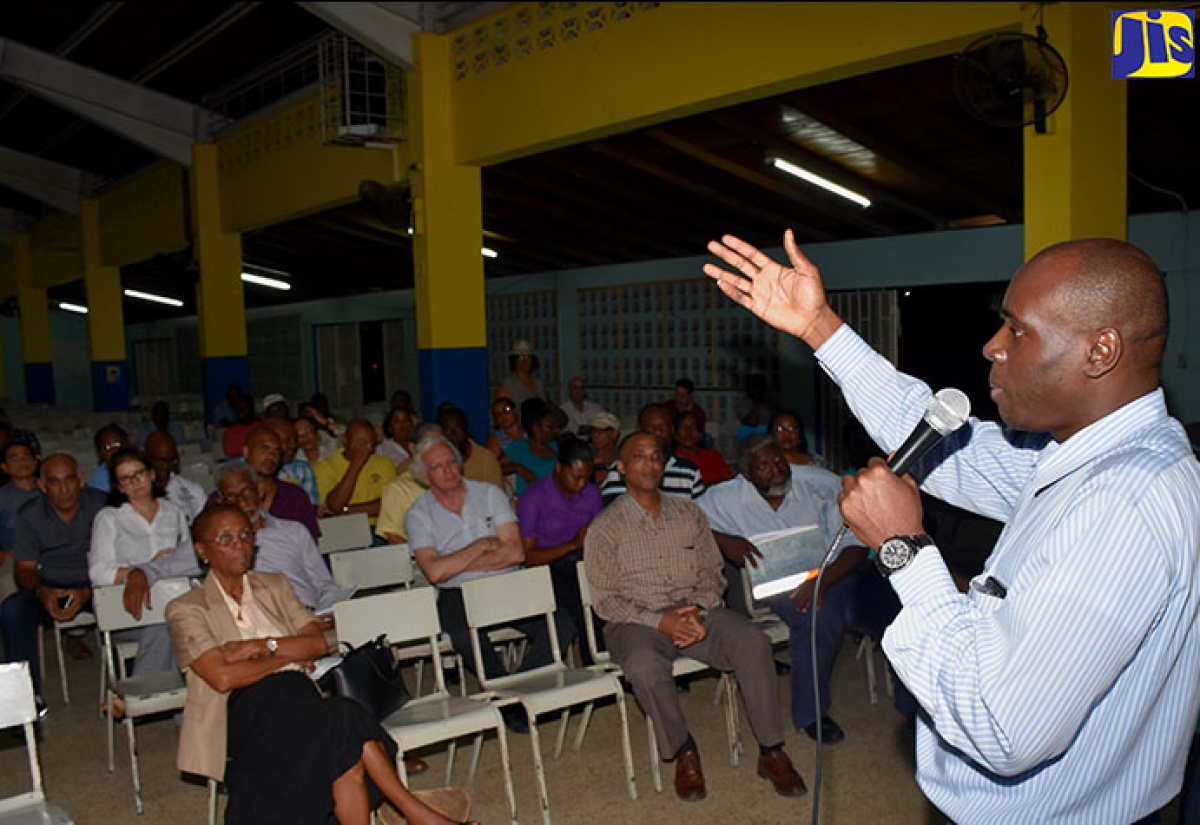 Communication and Customer Service Manager, National Works Agency, Stephen Shaw, addresses stakeholders on the Constant Spring road improvement project at the Karram-Speid Auditorium, Merl Grove High School, on Wednesday, November 29.