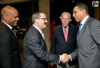 Prime Minister, the Most Hon. Andrew Holness (right), greets Managing Director of the United States investment firm, Jefferies; and Head of the entity’s Fixed Income Wealth Management division, Gregory Fisher (2nd left), on arrival at The Jamaica Pegasus hotel in New Kingston on Tuesday, January 24, for the opening ceremony of the 12th Jamaica Stock Exchange (JSE) Regional Investments and Capital Markets Conference. Others (from left) are:  JSE Chairman, Ian McNaughton; and The Jamaica Pegasus General Manager, Peter Hilary.
 
