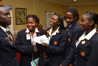 Students of the St. Andrew Technical High School are in light conversation just before the start of the Commonwealth Day 2015 Youth Forum held today (March 9), at the Knutsford Court Hotel in New Kingston. They are (from left): Jervorney Gordon; Lateesa McKenley; Daniel McLeod; Akeli Stampp; and Aaliyah Smith.