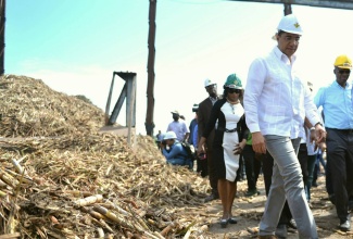 Prime Minister, the Most Hon. Andrew Holness (foreground), on a  tour of the Monymusk Sugar Factory, in Clarendon, on March 31. Occasion was the official reopening of the factory.