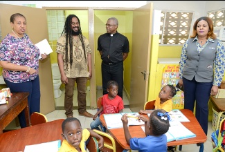 National Commercial Bank Foundation Director, Miguel Williams (second left) visits with students of the Majesty Gardens Infant School during a tour of the institution. The Foundation officially handed over renovated bathroom facilities valued at $450,000 to the school  on January 18.  Others (from left) are Chairman of the school, Greta Bogues; St. Andrew Parish Church Rector, Rev. Major Cannon Sirrano Kitson and NCB Hagley Park Road Branch representative, Lisa Wright.