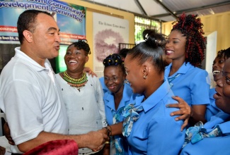 Health Minister and West Central St. Catherine Member of Parliament,  Dr. the Hon. Christopher Tufton (left), interacts with Early Childhood Instructor for the training programme for unattached youth, Arlene Brown (2nd left), and students during the initiative’s recent launch at the Kitson Town community resource centre.