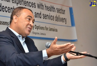 Health Minister, Dr. the Hon. Christopher Tufton emphasises a point during a Pan American Health Organisation/Ministry of Health forum on Health Sector Reform and Service Delivery, at the Jamaica Pegasus Hotel in New Kingston on July 28.  