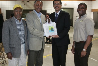 Jamaica’s Ambassador to the United States, His Excellency Stephen Vasciannie (2nd right), accepts a welcome package from Minneapolis City Council Member, Don Samuels (2nd left), on his arrival at the Redeemer Covenant Church in Minneapolis on May 9, for a town hall meeting. Sharing the moment are: President of the Organization of Strategic Development in Jamaica, Wayland Richards (left), and Fitzgerald Steele.