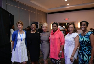 Culture, Gender, Entertainment and Sport Minister, Hon. Olivia Grange (second left), shares a photo moment with (from left) Marketing Consultant, Tara Playfair-Scott; Jamaica Public Service (JPS) Chief Executive Officer, Kelly Tomblin; JPS Board Director, Minna Israel; President, International Women Forum, Jamaica Chapter, Camille Facey; and Chief Executive Officer, Bahamas Power and Light, Pam Hill, during the second and final day of the JPS Women in Energy (WIE) Conference at the Jamaica Pegasus Hotel in New Kingston on March 10.