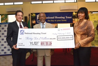 Prime Minister the Most Hon. Portia Simpson Miller (right); along with National Housing Trust (NHT) Chairman, Hon. Easton Douglas (centre); and Chairman, YUTE Limited, Joseph M. Matalon hold aloft a cheque for $32 million that the government, through the NHT, is providing in financial support for phase two of the Youth Employment Through Upliftment (YUTE) Build programme. Occasion was the signing of a Memorandum of Understanding for Phase 2 of the Programme, on February7 at the Office of the Prime Minister. 