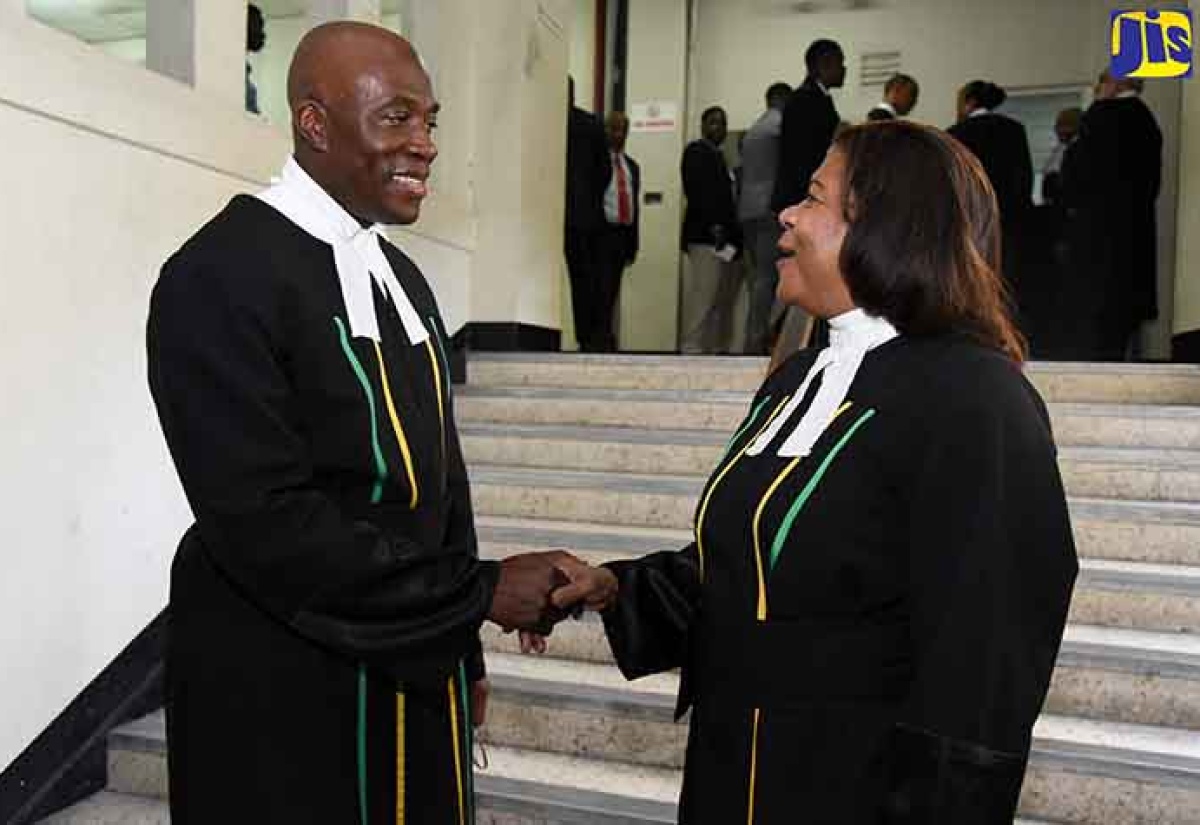 DSC 4277: Chief Justice, Hon. Justice Zaila McCalla (right), is greeted by Judge of the Supreme Court, Justice Bryan Sykes, after a special sitting of the Supreme Court to honour the outgoing Chief Justice, held at Public Building East, downtown Kingston, on January 31.