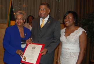 Jamaica’s Ambassador to the United States, His Excellency Ralph Thomas (centre) accepts a State of Maryland Resolution from Senator Shirley Nathan-Pulliam (left) welcoming him as Jamaica’s twelfth ambassador to the United States at a welcome reception held in his honour by the Embassy of Jamaica at St Gregory Hotel in Washington D.C. on Thursday October 8. Sharing in the occasion (right) is Mrs. Sandra Dixon-Thomas, wife of the Ambassador.