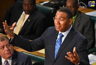 Prime Minister, the Most Hon. Andrew Holness (right), addresses the House of Representatives on February 13. At left is Minister of Finance and the Public Service, Hon. Audley Shaw.