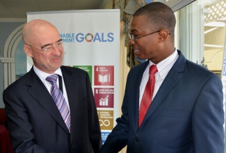 Minister of State in the Ministry of Foreign Affairs and  Foreign Trade, Hon. Arnaldo Brown (right), is greeted by the United Nations Development Programme (UNDP)  Resident Coordinator, Bruno Pouezat, at the University of the West Indies, Mona Campus, in St. Andrew, today (September 28), where he addressed a Social Good Summit. The summit was hosted by  the UNDP – Jamaica, to highlight transition from the Millennium Development Goals (MDGs) to the Sustainable Development Goals.   