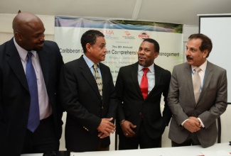 Minister of Local Government and Community Development, Hon. Noel Arscott (2nd left), is in light conversation with Executive Director of the Caribbean Disaster Emergency Management Agency (CDEMA), Ronald Jackson (2nd right); Resident Representative, United Nations Development Programme (UNDP), Dr. Arun Kashyap (right); and Acting Director General, Office of Disaster Preparedness and Emergency Management (ODPEM), Richard Thompson. Occasion was the launch of the 8th Annual Caribbean Conference on Comprehensive Disaster Management (CDM) held on September 4, at the Spanish Court hotel in New Kingston.
