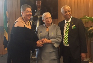 High Commissioner to London, Her Excellency Aloun Ndombet-Assamba (left), presents a special award to Delores Cooper, OD  for two decades of service to Jamaica and the United Kingdom (UK) Diaspora. Occasion was an Independence Day Reception hosted by the High Commission at the International Maritime Organization (IMO) in London on August 5. Sharing the moment is Honorary Consul, Wade Lyn.