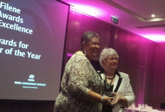 High Commissioner to the United Kingdom (UK), Her Excellency,  Aloun Ndombet-Assamba (left),  receives the ‘Joe Biden Development Educator of the Year  2014-2015’ Award for the  Caribbean, from Trustee of the International Credit Union Leadership Development and Education Foundation, Marilynne Epstein. The presentation was made at a ceremony in London on Saturday, November 14.