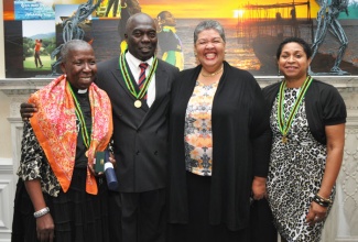 Jamaica’s High Commissioner to the United Kingdom (UK), Her Excellency Aloun Ndombet Assamba (2nd right), shares with the three UK recipients of the Prime Minister’s Medal of Appreciation. From left are Cannon Evadne Pitts from Birmingham;  Carlton Moody of the Lambeth Cricket Academy;  and Attorney Barbara Ledgister.  Mr. Moody and Rev Pitts received their awards at a special cultural evening  recently hosted by the High Commission. Ms Ledgister received her medal at the official ceremony held in Jamaica in July.