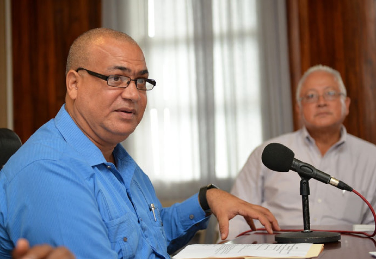 State Minister in the Ministry of Transport, Works and Housing, Hon. Richard Azan (left), addressing a ceremony at the Ministry, Maxfield Avenue,  Tuesday, August 18, for the construction of a new bridge on Barbican Way, in St. Andrew. Looking on is Member of Parliament for North East St. Andrew, Delroy Chuck.