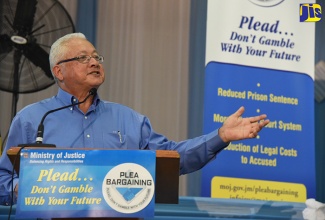 Minister of Justice, the Hon. Delroy Chuck addresses the audience at the Ministry of Justice’s Town Hall Meeting held at St. George’s College Auditorium in Downtown, Kingston on November 2.