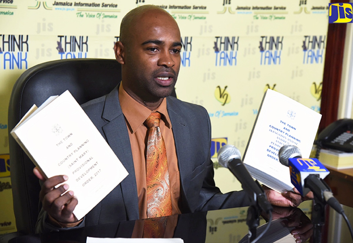 Manager of the Local Area Planning Branch at the National Environment and Planning Agency (NEPA), Dwight Williams, shows two of the most recent development orders that have been promulgated at a recent JIS ‘Think Tank’. A development order is a legal document which sets out the framework, guidelines and policies for planning and development in parishes and communities.