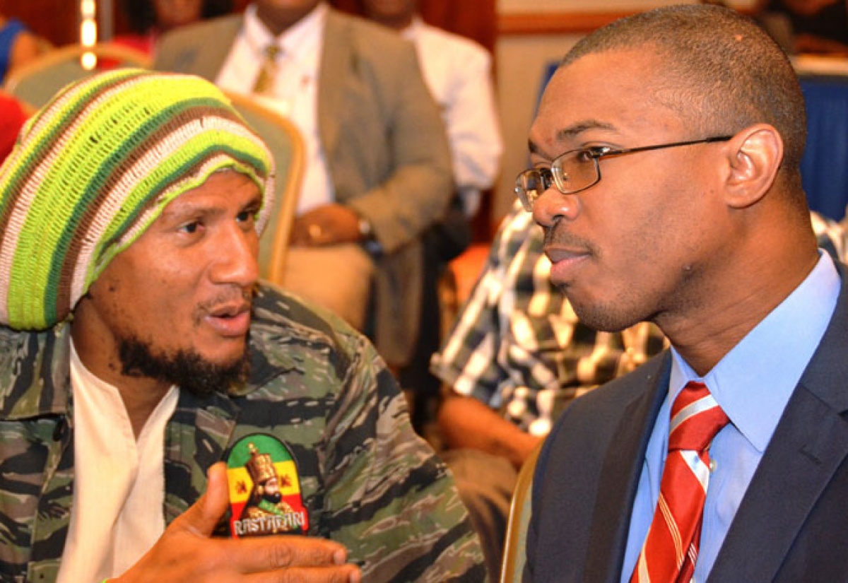 Minister of State in the Ministry of Foreign Affairs and Foreign Trade, Hon.
Dr. Arnaldo Brown (right), in conversation with University of the West Indies Lecturer, Dr. Kadamawe K'nife, during the Mona School of Business and Management's Inaugural Business conference, held on January 8 at the Holiday Inn Sun Spree Resort in Montego Bay. The conference was held from January 7 to 9 under the theme: 'Breaking the
barriers: enterprise, competitiveness, growth and development'.
