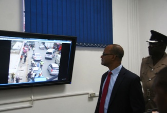 Minister of National Security, Hon. Peter Bunting (left) and Assistant Commissioner of Police in charge of Area One, Warren Clarke (right) views activities on a street in downtown Montego Bay, from a monitor within the control room of the Montego Bay Closed Circuit Television Surveillance System, on Thursday September 5. The demonstration followed the official handing over of the system by the National Security Minister to the Montego Bay Police.  The system was financed by the Ministry of National Security in the sum of $55 million.