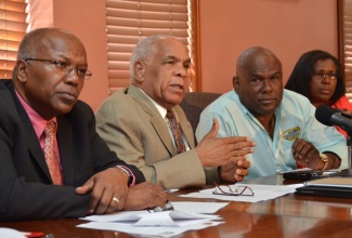 Minister of Transport, Works and Housing, Dr. the Hon. Omar Davies (second left),  announces a 25 per cent increase in fares for the public transportation sector, at a press conference held on August 19 at the Ministry’s Maxfield Avenue offices. Looking on (from left) are: Minister without Portfolio in the Ministry of Transport, Works and Housing, Hon. Dr. Morais Guy; Chief Executive Officer, Jamaica Urban Transit Company, Colin Campbell and  Permanent Secretary in the Ministry, Mrs. Audrey Sewell.