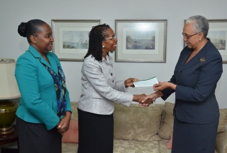 Permanent Secretary in the Ministry of Education, Elaine Foster Allen (centre), accepts a cheque valued at US$6,000 from Acting Permanent Secretary in the Ministry of Foreign Affairs and Foreign Trade, Margaret Jobson (right) during a brief handing over ceremony on July 31, at the Ministry of Foreign Affairs’ New Kingston offices. Sharing the moment is Chief Education Officer in the Ministry, Grace McLean. The money, which represents proceeds from the Japan-Latin American and Caribbean Ladies Association 2012 Charity Bazaar, will be presented to the Balcombe Drive Primary and Junior High School in St. Andrew.