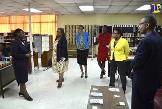 New Chairman of the Jamaica Information Service (JIS) Advisory Board, Mrs. Gail Abrahams (second right), listens keenly as Manager for JIS’s Research and Publications Department, Celia Lindsay (left), explains the operations of that office. Mrs. Abrahams, along with other Board members, were on a tour of the agency’s Half-Way-Tree Road head office, today (April 25). Also pictured (at third left), is Chief Executive Officer (CEO) of the JIS, Mrs. Donna-Marie Rowe. Board members (from second left) are Sharon Hay-Webster; Novelette Howell; and Garfield Higgins. Prior to the tour, the Board held their first meeting with JIS’s management team.