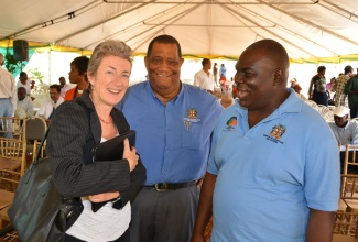 Minister of Agriculture and Fisheries, Hon. Roger Clarke (centre), shares a light moment with Head of the European Union Delegation, Ambassador Paola Amadei (left) and Permanent Secretary in the Ministry, Donovan Stanberry, at the handing over of housing units to sugar workers of Trelawny. The ceremony was held in Spicy Hill, on February 6.